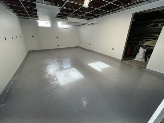 Kitchen floor system + cove base - This is an urethane/epoxy-coated surface, which is highly durable, resistant to stains, scratches, and chemicals, making it ideal for kitchens, basements, garages, or workspaces. Its seamless, glossy finish is easy to clean, enhances the room’s appearance, and provides protection against moisture and wear. Kitchen floor system + cove base - This is an urethane/epoxy-coated surface, which is highly durable, resistant to stains, scratches, and chemicals, making it ideal for kitchens, basements, garages, or workspaces. Its seamless, glossy finish is easy to clean, enhances the room’s appearance, and provides protection against moisture and wear.
