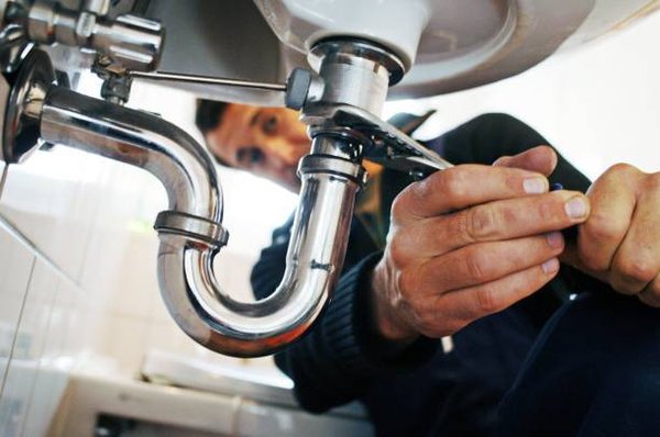 Plumbers at work - Plumbers doing plumbing Plumbers at work - Plumbers doing plumbing