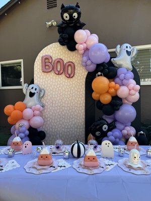 Halloween Party - A spooky cute kids halloween party that included a double backdrop with custom covers, organic balloon garland display, foil balloon accents, and full table styling. Table styling included place settings for 12 children, custom name cups and spooky accents.