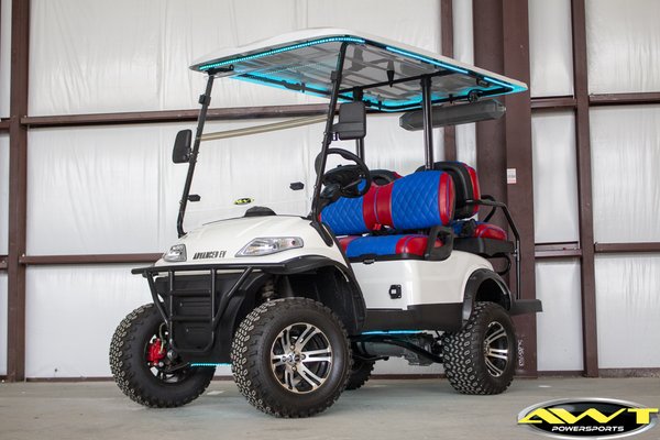 2021 White Custom Advanced EV1 4 seater - This 2021 Advanced EV 4 seater golf cart started with ordinary black seats. After we finished adding that AWT touch it rolled out of here with roof and body under-glo lighting, custom diamond stitched seats, and a soundbar.