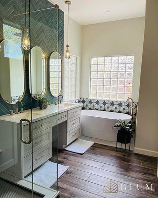 Master Bathroom Remodel – Ventura - We fully remodeled this primary bathroom for our clients in Ventura. The layout stayed the same, but everything else was replaced. We removed the outdated vanity, lighting, and tub and installed a new custom double vanity with a center makeup station, quartz countertops, new brass fixtures, and vertical lighting. We retiled the shower, installed a new bench, added a freestanding tub, and finished with all new flooring, mirrors, and lighting. Master Bathroom Remodel – Ventura - We fully remodeled this primary bathroom for our clients in Ventura. The layout stayed the same, but everything else was replaced. We removed the outdated vanity, lighting, and tub and installed a new custom double vanity with a center makeup station, quartz countertops, new brass fixtures, and vertical lighting. We retiled the shower, installed a new bench, added a freestanding tub, and finished with all new flooring, mirrors, and lighting.