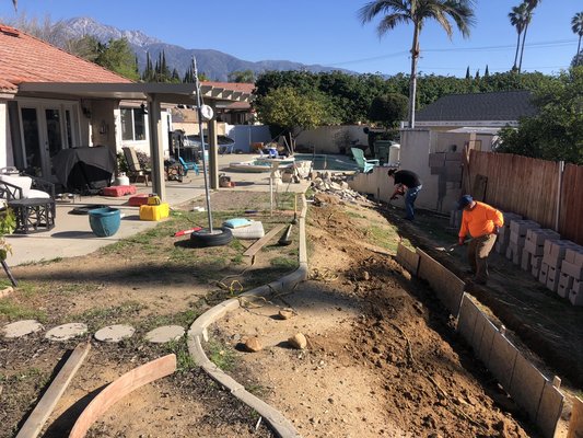 Back yard remodeling - For this job we built a retaining wall so we could expand the paved area adding a couple hundred square feet of functional space for the homeowner. The paver is a Belgard brand Catalina Grana pattern in Bella color. We kept the existing concrete around the pool. The turf is a Tiger turf brand Everglade fescue. Back yard remodeling - For this job we built a retaining wall so we could expand the paved area adding a couple hundred square feet of functional space for the homeowner. The paver is a Belgard brand Catalina Grana pattern in Bella color. We kept the existing concrete around the pool. The turf is a Tiger turf brand Everglade fescue.