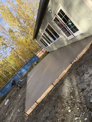 Eek st driveway - Tore out the existing driveway and sidewalk and replaced it with a nice broom finished concrete slab