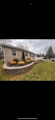 Retaining wall/Landscape services - Customers wanted retaining wall replaced and landscape bed brought to ground level using existing plants. Aswell with some simple plastic edging and Canadian nuggets.