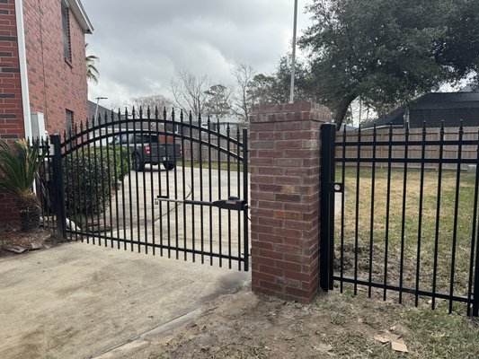 Driveway gate project 2025 Northshore - On this particular project we built and install 1) arched driveway gate and 1) double rail walk gate.

We closed off the gaps with custom made wrought iron panels double rail with ball point tops.

The column was also done by us, 24”x24” 6’ tall with internal conduit for electrical run.

Beautiful project all done by us. For more details click the link us a call!