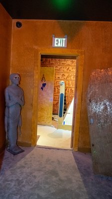 Ancient Egypt Escape Room - You are a team of archaeologists invited to join Professor Stanley Croft’s Egyptian expedition. However, upon arrival, you discover the professor has been missing for a few days. With time running out, you decide to delve into one of the deeper, unexplored tombs in search of him. But as you enter, the stone door collapses behind you! You know there’s a sandstorm arriving in 60 minutes, and if you can’t find another way out, you just may become part of history...
The Ancient Egypt Escape Room is an immersive, multi-room adventure that challenges your team with a mix of cerebral and physical puzzles. As you explore the tomb’s hidden chambers, you’ll decode ancient hieroglyphics, solve intricate puzzles, and race against the clock to escape. The room’s floor is entirely covered in sand, adding an extra layer of realism to your journey, so be sure to wear appropriate shoes! Ancient Egypt Escape Room - You are a team of archaeologists invited to join Professor Stanley Croft’s Egyptian expedition. However, upon arrival, you discover the professor has been missing for a few days. With time running out, you decide to delve into one of the deeper, unexplored tombs in search of him. But as you enter, the stone door collapses behind you! You know there’s a sandstorm arriving in 60 minutes, and if you can’t find another way out, you just may become part of history...
The Ancient Egypt Escape Room is an immersive, multi-room adventure that challenges your team with a mix of cerebral and physical puzzles. As you explore the tomb’s hidden chambers, you’ll decode ancient hieroglyphics, solve intricate puzzles, and race against the clock to escape. The room’s floor is entirely covered in sand, adding an extra layer of realism to your journey, so be sure to wear appropriate shoes!