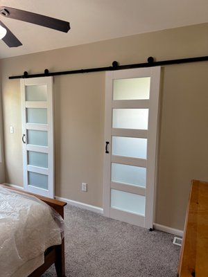 Bathroom Remodel Double Barn Door Closet & Bath - What a way to make barn doors look modern and clean! My client stated that she disliked her swing doors opening into the closet & bath. Rather than flipping them and making them swing out she wanted them turned into sliding doors without the old and dated feel of barn doors. I suggested a more modern approach with a single rail and frosted glass panels. Here is the result! Bathroom Remodel Double Barn Door Closet & Bath - What a way to make barn doors look modern and clean! My client stated that she disliked her swing doors opening into the closet & bath. Rather than flipping them and making them swing out she wanted them turned into sliding doors without the old and dated feel of barn doors. I suggested a more modern approach with a single rail and frosted glass panels. Here is the result!