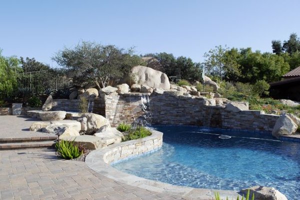 Murrieta Job in LaCresta - This project was finished in early 2018. We broke through 3 ft. of solid rock while excavating the pool. Several real boulders were saved and used around the pool in the construction of real rock waterfalls. The stone used was Mt. Moriah, the decking was done in pavers and the pebble finish was Blue Surf Pebble Sheen with 30% added blue rock. Murrieta Job in LaCresta - This project was finished in early 2018. We broke through 3 ft. of solid rock while excavating the pool. Several real boulders were saved and used around the pool in the construction of real rock waterfalls. The stone used was Mt. Moriah, the decking was done in pavers and the pebble finish was Blue Surf Pebble Sheen with 30% added blue rock.