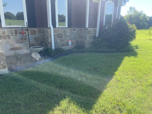 Garden Bed Remodel - This garden bed was in bad shape with old mulch and weeds everywhere. We removed everything, brought 2” of fresh topsoil in with dark brown mulch and added a millsap stone border around the full bed.