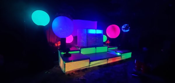 Private Backyard Event - Being a mobile service we can set up something like this in YOUR backyard!
Pictured is a custom stage, projection mapped, with our one of a kind Lumashpere lights (the colored balls of lights), a DJ booth, intimidator lights, and stretch fabric being projected onto.