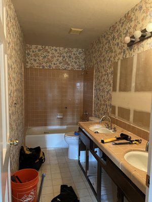 Los altos bathroom remodeling. - The old bathroom has a old style bathtub ,single sink and wall paper walls .The new bathroom is a steam shower bathroom and has a curb less shower base with tile ,a niche with wood shelves, glass shower doors ,new double sink with quartz countertops , electric towel rack , Led mirror and smooth finish for the walls level 5.