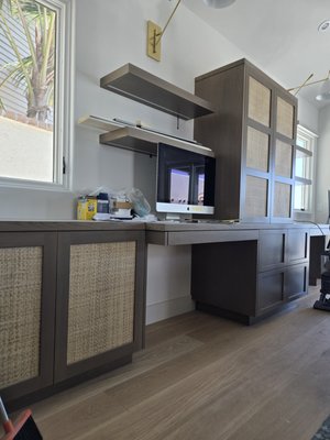 Monterey Dr. Casita - Custom cabinetry for la casita at a home in Laguna Beach. Beautiful blue cabinets in the kitchen, gray in the bathroom, and stain grade white oak for the desk area and kitchen island. Rattan inserts in some of the desk cabinets give a wonderful feel to the space. Along with the beachy blues and white walls, this set of cabinetry couldn't be more fitting for the space.