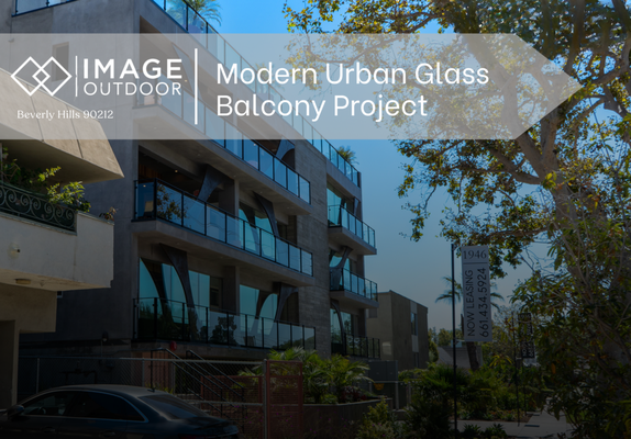 Modern Glass Balcony - This project showcases a beautifully executed glass balcony railing system by Image Outdoor, installed on a modern multi-unit residential building. The sleek black powder-coated metal framing paired with clear tempered glass panels delivers an open, airy feel while ensuring safety and durability. The geometric concrete architecture is emphasized by the minimalist railing design, allowing the building's bold structure to remain the focal point. Strategically placed lighting under each balcony enhances visibility and ambiance. This project demonstrates how modern materials and clean lines can elevate urban living spaces with elegance and structural integrity. Modern Glass Balcony - This project showcases a beautifully executed glass balcony railing system by Image Outdoor, installed on a modern multi-unit residential building. The sleek black powder-coated metal framing paired with clear tempered glass panels delivers an open, airy feel while ensuring safety and durability. The geometric concrete architecture is emphasized by the minimalist railing design, allowing the building's bold structure to remain the focal point. Strategically placed lighting under each balcony enhances visibility and ambiance. This project demonstrates how modern materials and clean lines can elevate urban living spaces with elegance and structural integrity.