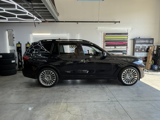 BMW wrap, paint correction, ceramic coating, and new roof rails. - Customer’s BMW SUV equipped with new black roof rails, some chrome delete, paint corrected and ceramic coated exterior.