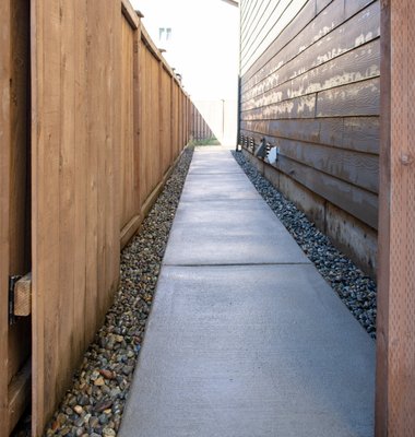 Concrete Walkway and Pad - Client requested a concrete walkway, connecting the driveway with their back patio. Optional exposed aggregate concrete finished is offered. Concrete Walkway and Pad - Client requested a concrete walkway, connecting the driveway with their back patio. Optional exposed aggregate concrete finished is offered.