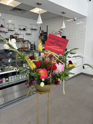 "Grand Opening Splendor" Floral Arrangement - Welcome new beginnings with our exquisite "Grand Opening Splendor" floral arrangement, designed to celebrate and elevate the joy of inaugurating a new store, restaurant, or company.

Each flower is carefully selected to create a harmonious and sophisticated arrangement that radiates success and optimism. The "Grand Opening Splendor" is more than just a bouquet; it's a statement piece that enhances the celebratory atmosphere and leaves a lasting impression on your guests.

Make your grand opening unforgettable with this magnificent arrangement. Contact us today to add a touch of floral elegance to your special event.