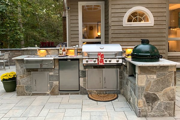 Outdoor Castle in the Woods - East Coast transformed this family’s cramped, crumbling backyard into a beautiful outdoor castle in the woods protected by high stone walls and filled with new outdoor living experiences. Our clients can now enjoy a balcony overlooking the beauty of nature, a lounging area by the pool to take in the sun, an outdoor kitchen to grill and a large outdoor dining space to enjoy meals together. Beautiful and well-lit walkways, steps and gate allow for safe entry and exit.

FEATURES: 

> Backyard patio
> Outdoor kitchen
> Pool deck
> Retaining walls (bordering entire patio)
> Walkways & steps
> Plantings
> Path lighting
> Drainage
> Front porch & walkway