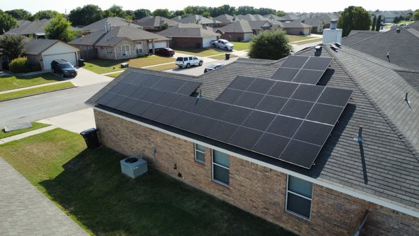 Suburban Solar Project - This residential solar installation features a sleek array of all-black panels, perfectly aligned on the rooftop to maximize energy production. The system is designed to seamlessly integrate with the roof's design, maintaining both the aesthetic appeal and functionality. This project provides the homeowner with sustainable energy, reducing reliance on the grid while cutting down on electricity costs. The installation showcases how residential properties can efficiently transition to clean energy solutions without compromising the home's visual appeal.