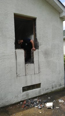installing door - This model of a house we kicked out a wall to put a door in.