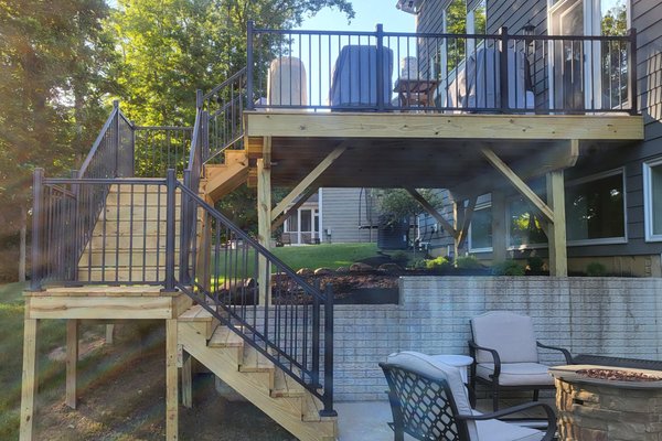 Make your comfort more accessable - This deck was a complete rebuild. It started as an upper deck with a straight stairwell to the ground where the clients had to then descend a grass hill to get to the patio. Working with the clients we developed a design that worked to make their backyard an easy transition from one relaxing environment to the next safely.