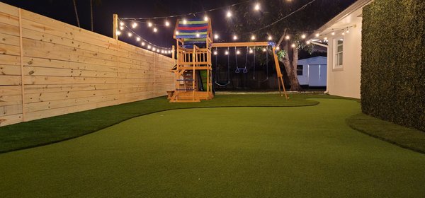 Ultimate Side-of-Home Upgrade - Featuring a padded playground, four hole putting green, boxwood ivy walls to enclose and hide utilities and trash receptacles, lush premium grade turf, and modern lighting, the side of this home became the most iconic aspect of the family's home! Ultimate Side-of-Home Upgrade - Featuring a padded playground, four hole putting green, boxwood ivy walls to enclose and hide utilities and trash receptacles, lush premium grade turf, and modern lighting, the side of this home became the most iconic aspect of the family's home!