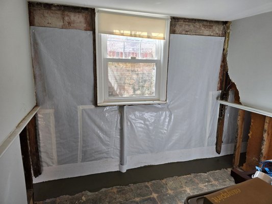 Interior Basement Waterproofing - This basement wall was leaking and causing the finished wall to deteriorate.  We removed the old wall covering, installed our waterproofing materials, and the owner was able to refinish the new dry area.