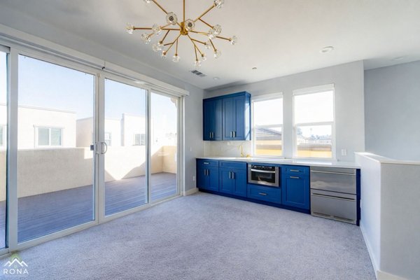 Inglewood Custom Blue Wet Bar Installation - This custom wet bar in Inglewood, CA was designed to create a stylish and functional entertainment space. The project features deep blue shaker cabinets with gold hardware, quartz countertops, a modern gold faucet, and stainless steel appliances including a built-in microwave and beverage fridge. Large windows bring in natural light, highlighting the clean finishes and contemporary design. Inglewood Custom Blue Wet Bar Installation - This custom wet bar in Inglewood, CA was designed to create a stylish and functional entertainment space. The project features deep blue shaker cabinets with gold hardware, quartz countertops, a modern gold faucet, and stainless steel appliances including a built-in microwave and beverage fridge. Large windows bring in natural light, highlighting the clean finishes and contemporary design.
