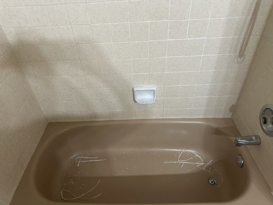Re-sealing bathtub - This bathtub needed to be re-sealed in certain sections, but to get a proper seal around the entire tub we needed to remove all of the old caulking in order for the new caulking to get a better, long lasting seal.