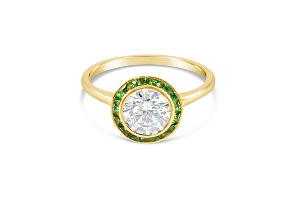Custom Halo Engagement Ring with Tsavorite Stones - One of our customers came to us with the idea of using Tsavorite Stones, also known as African Green Garnets. The stone held a unique emotional connection for this couple. Having never worked with this stone before, we searched and found the son of the man who discovered Tsavorite. After hearing about our project, he volunteered to hand-cut the stones. He personally flew them with him from Africa to the US, and we were able to hand-fabricate this ring. It was a complex and challenging project, but the results were STUNNING! Custom Halo Engagement Ring with Tsavorite Stones - One of our customers came to us with the idea of using Tsavorite Stones, also known as African Green Garnets. The stone held a unique emotional connection for this couple. Having never worked with this stone before, we searched and found the son of the man who discovered Tsavorite. After hearing about our project, he volunteered to hand-cut the stones. He personally flew them with him from Africa to the US, and we were able to hand-fabricate this ring. It was a complex and challenging project, but the results were STUNNING!