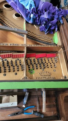New Piano Strings for a 1927 Baldwin G! - This beautiful 1927 Baldwin G be had old rusty strings and pins when we started. The action was also old with all original parts and it needed to be refurbished as well. We have already refurbished the action, now we are in the process of restringing the entire piano. We had new bass strings custom made for this piano. It will come out beautiful with new nickel plated pins