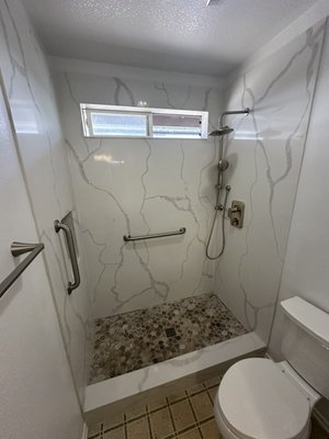 Shower panels bathroom remodel in Long Beach, CA - For this project we put up the calacatta white quartz countertops, shower niche, travertine mosaic for shower floor and niche, step is of same quartz material. Then directly across the shower you’ll find the stone grey cabinets which the matching quartz countertop with undermount sink, 6” backsplash. We also installed the mirror and medicine cabinet. Bathroom floor was not wanted by customer. Shower panels bathroom remodel in Long Beach, CA - For this project we put up the calacatta white quartz countertops, shower niche, travertine mosaic for shower floor and niche, step is of same quartz material. Then directly across the shower you’ll find the stone grey cabinets which the matching quartz countertop with undermount sink, 6” backsplash. We also installed the mirror and medicine cabinet. Bathroom floor was not wanted by customer.