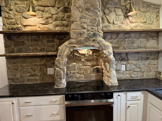 Sharon’s custom kitchen wall - This was a complete custom job shelves were cut from raw wood and wall and chimney around stove were done completely by hand to add this incredible looking kitchen