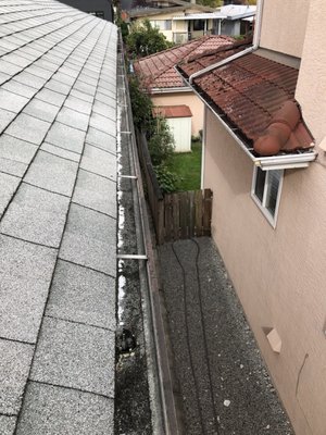 Gutter Clean and Repairs in East Vancouver - Susan needed her gutters cleaned. We also resealed 3 gutter joints, a roof jack pipe, some exposed nails, installed downspout guards, and repaired some rust on a vent.