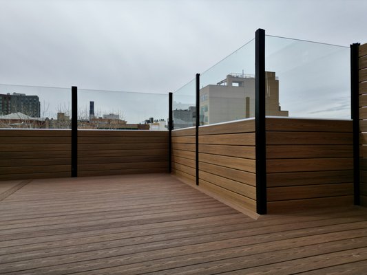 Rooftop Lounge in Bed Stuy, Brooklyn - We built this gorgeous roof deck using Fiberon Bungalow and Tuscan Villa lines. The street facing side features an 8 foot fence to provide privacy from the building across while the opposite side fence is split in half between composite boards and tempered glass panels. Rooftop Lounge in Bed Stuy, Brooklyn - We built this gorgeous roof deck using Fiberon Bungalow and Tuscan Villa lines. The street facing side features an 8 foot fence to provide privacy from the building across while the opposite side fence is split in half between composite boards and tempered glass panels.