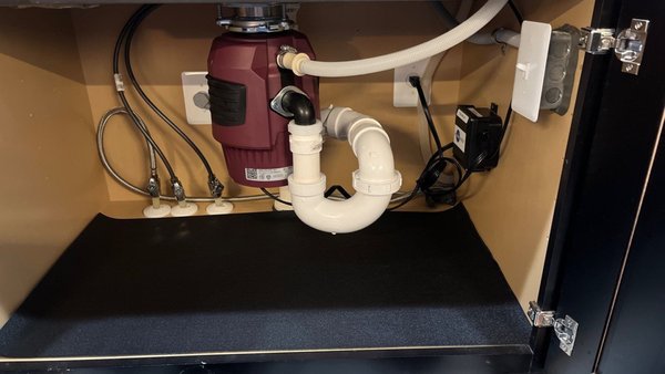Garbage Disposal Renovation & Toilet Install - This homeowner wanted a garbage disposal installed on their island kitchen. The previous homeowner had it removed for their own reasons. This homeowner wanted a high-power, quiet model and that is what we gave! We also included a sink-top switch so they activate the waste grinder without having to open up the cabinet every time they want to turn the unit on! Drain size and trap were upgraded back to 2" pipe size and added an air admittance valve for air flow within the drain piping. We also removed all of the sagging hose in the dishwasher discharge hose by bringing it up higher to create a high loop.  To top it all off, we put a liner down for a nice clean look after vacuuming and sweeping out all debris from underneath when finished!