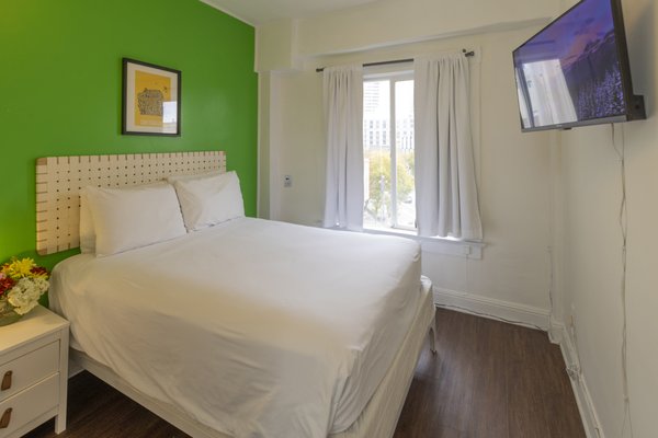 Economy Double Room with Ensuite Bathroom - Our Economy Double Rooms are perfect for budget travelers. Located in a quiet area facing the back of the building, they offer a comfortable double bed, a 32” Class LED HD Smart TV with streaming services, and ample natural light. Enjoy a serene and cozy stay with all the essentials.