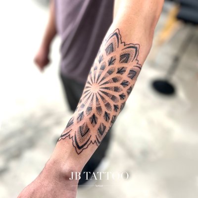Mandalas - At JB tattoo, we take pride in crafting stunning mandala tattoos that reflect the individuality and stories of each of our customers. Each piece is meticulously designed to capture the essence of the wearer, blending intricate patterns and personal symbolism.

Project Highlights:

Personal Journey: One customer wanted a mandala that represented their journey through life. We incorporated elements like a compass and flowers to symbolize growth and direction, creating a beautiful piece that tells a powerful story.

Cultural Significance: Another client desired a mandala inspired by their heritage. We worked together to integrate traditional motifs, resulting in a design that honors their roots while being uniquely theirs.

Spiritual Connection: A client approached us for a spiritual mandala tattoo to symbolize mindfulness and balance. We designed a harmonious piece featuring sacred geometry, infusing it with personal meanings that resonate deeply with their spiritual journey.

Nature Inspired: For a nature lover, we created a mandala incorporating elements of the earth—leaves, flowers, and waves. This design beautifully reflects their connection to nature and serves as a reminder of their love for the outdoors.

Each mandala tattoo we create is a collaboration, ensuring that our clients leave with a piece of art that is as meaningful as it is beautiful. Come visit us at JB tattoo to start your own mandala journey!
