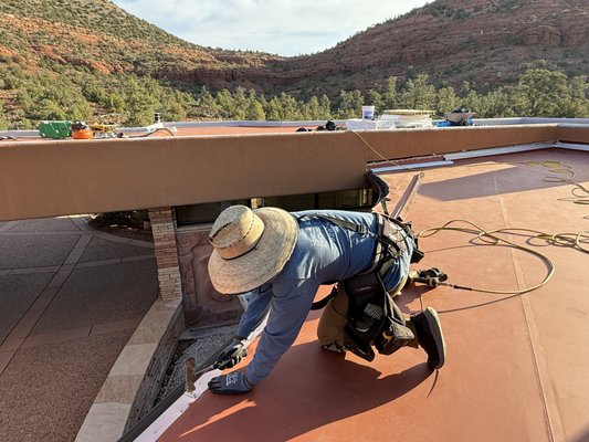 TPO RE-ROOF - This was a great project on a 22 year old home in Sedona, Arizona. The original roof was a built-up gravel roof system. We re-roofed this home with a premium 60 MIL Terra Cotta TPO, Single ply roof system. This roof has a 25 year lifespan, and comes with an outstanding 20 year material warranty. Also on this roof, we reinforced all of the interior stucco parapet walls, with our 5 Ply shield coat, elastomeric compound. We know those pesky flat roofs can be problematic. Don't wait for a disaster, give us a call! TPO RE-ROOF - This was a great project on a 22 year old home in Sedona, Arizona. The original roof was a built-up gravel roof system. We re-roofed this home with a premium 60 MIL Terra Cotta TPO, Single ply roof system. This roof has a 25 year lifespan, and comes with an outstanding 20 year material warranty. Also on this roof, we reinforced all of the interior stucco parapet walls, with our 5 Ply shield coat, elastomeric compound. We know those pesky flat roofs can be problematic. Don't wait for a disaster, give us a call!