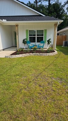 Stone Edging & Brown Mulch 2026 - This front landscape transformation gave this home a clean, welcoming curb appeal. Our team installed a custom limestone block edging, added fresh topsoil to create healthy planting beds, spread rich brown mulch for a polished finish, and carefully selected and planted new flowers and shrubs to bring the space to life. A simple upgrade that makes a big first impression.