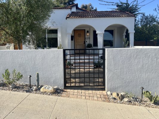 Highland Park Courtyard - A Mediterranean inspired courtyard with wrought iron gate, reclaimed brick path and porch.
