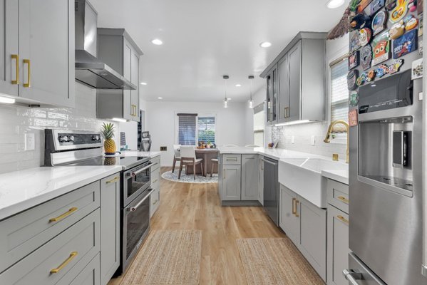 Custom Kitchen Remodeling by King David Home Builders in San Jose, CA - When we stepped into this San Jose kitchen, it was clear the space needed more than a facelift. It needed better flow, smarter storage, and a cleaner aesthetic. King David Home Builders approached this remodel with an emphasis on practical design that feels intentional in every detail.
The soft gray cabinetry grounds the space while allowing the brushed brass hardware to subtly stand out. Instead of going for bold contrasts, we kept the palette refined, pairing the cabinets with polished white quartz countertops and a lightly textured tile backsplash. The result is a kitchen that feels calm, cohesive, and thoughtfully layered.
Lighting was another priority. We used a mix of recessed lighting for even coverage and glass pendant fixtures above the peninsula to bring warmth to the dining area. This layout didn’t just improve the look, it made the space work better. The open transition from kitchen to dining allows for easier movement while keeping everything within reach.
A deep farmhouse sink, integrated dishwasher, and stacked wall ovens make the work zones efficient. Storage extends all the way into the adjacent laundry area with full-height custom cabinetry, adding both utility and uniformity to the overall space.
This remodel didn’t rely on statement pieces or loud design trends, just smart choices that add up to a kitchen built for daily living and lasting style.
Ready to bring structure, style, and function to your kitchen? Reach out to King David Home Builders today and let’s build your upgrade. Custom Kitchen Remodeling by King David Home Builders in San Jose, CA - When we stepped into this San Jose kitchen, it was clear the space needed more than a facelift. It needed better flow, smarter storage, and a cleaner aesthetic. King David Home Builders approached this remodel with an emphasis on practical design that feels intentional in every detail.
The soft gray cabinetry grounds the space while allowing the brushed brass hardware to subtly stand out. Instead of going for bold contrasts, we kept the palette refined, pairing the cabinets with polished white quartz countertops and a lightly textured tile backsplash. The result is a kitchen that feels calm, cohesive, and thoughtfully layered.
Lighting was another priority. We used a mix of recessed lighting for even coverage and glass pendant fixtures above the peninsula to bring warmth to the dining area. This layout didn’t just improve the look, it made the space work better. The open transition from kitchen to dining allows for easier movement while keeping everything within reach.
A deep farmhouse sink, integrated dishwasher, and stacked wall ovens make the work zones efficient. Storage extends all the way into the adjacent laundry area with full-height custom cabinetry, adding both utility and uniformity to the overall space.
This remodel didn’t rely on statement pieces or loud design trends, just smart choices that add up to a kitchen built for daily living and lasting style.
Ready to bring structure, style, and function to your kitchen? Reach out to King David Home Builders today and let’s build your upgrade.