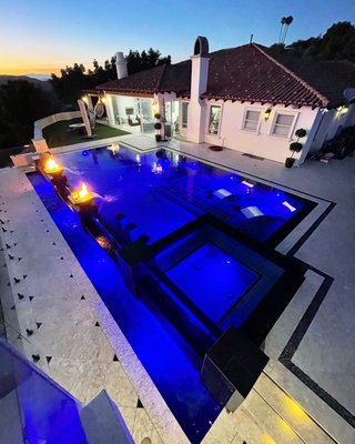 Temecula Estate - This pool and yard was not appealing to the homeowner as it was missing the big picture..."The View". This design was rendered with Pool Studios 3D to the homeowners so that they can visualize the potential that we saw. After approvals, we demolished the old pool and spa with decking to clear room for the new design. We built a completely new outdoor retreat consisting of; Infinity edge and zero edge pool and spa with acrylic panels, imported travertine coping and pavers, 3 story outdoor BBQ area with all the bells and whistles, upper lookout deck, spiral staircase, lower driveway with storage garage, lighting everywhere, walls, acrylic safety fences and so much more!