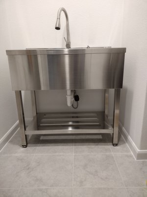 3 compartment stainless steel sink added in laundry room - this installation was wanted by customer and so I tapped into half bath lav on the other side of wall of the laundry room added water and drain for sink to properly work in laundry room beginning to end