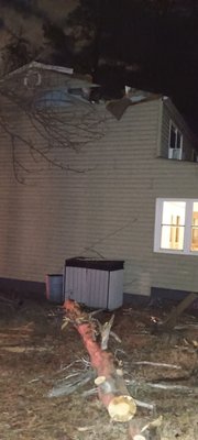 an emergency job we did.a tree that uprooted due to high winds we removed off house and applied a tarp for the customer - an emergency job we got called out on in the middle of the night.a tree uprooted due to high winds that we removed off the house for a customer and applied a tarp.
