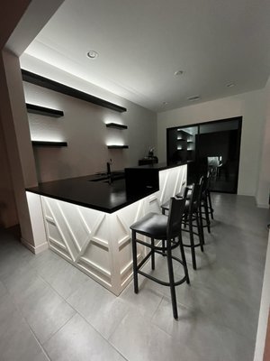 Home bar - This home bar was made out of a variety of different materials. The countertops were sprayed with a L12 high gloss 2k Poly and had a recessed LED channel under-mount. The bar was made in three sections each roughly 8 feet long. I spliced all the wires to a dimmer. I also made all 5 floating shelves to match the countertops. This was a fun project that I hope to do again.