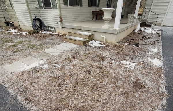 Brushed Pad with Two Sets of Steps - Lockport, NY - Completed a great new landing pad walkway with two sets of steps. This one was just a regular gray broomed finish and seal to prevent slipping. The original groundwork had a thin walkway done in chunks, our redesigned landing opened the surface up right to the corner of the house and out to the edge of the steps. The two old wooden stair sets (on the pad and on the far side by the driveway) were redone in concrete to last the homeowner for years. This was a two day job with tear out and setup on day 1, pour and finish on day 2 with a return to seal and saw cut real quick to finish it up.