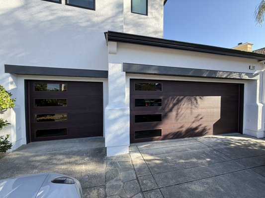 custom mahogany garage door - This project features custom mahogany garage doors with tinted glass, finished with white powder-coated track and hardware for a clean, modern look.
We also installed a custom high-lift system to maximize overhead space and give the doors a smooth, upgraded operation. custom mahogany garage door - This project features custom mahogany garage doors with tinted glass, finished with white powder-coated track and hardware for a clean, modern look.
We also installed a custom high-lift system to maximize overhead space and give the doors a smooth, upgraded operation.