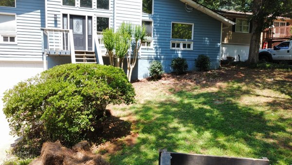Flower bed conversion - This job consisted of a border with large river rock and long needle pine straw to accent the house Flower bed conversion - This job consisted of a border with large river rock and long needle pine straw to accent the house