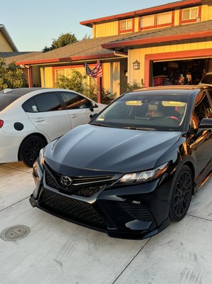 2023 Camry wrapped (hood & trunk) in our gloss carbon fiber. - This customer wanted his Camry to stand out from the rest. He chose the gloss carbon fiber hood and trunk. In my opinion the trunk is the real show stopper. The fantastic thing about this film is that it looks like real carbon fiber.