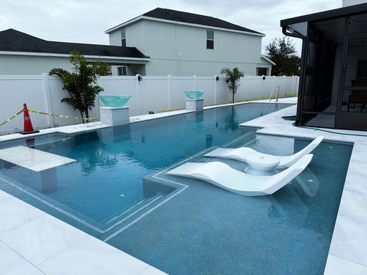 Custom Pool with Water Features - We plastered this Pool with a mini pebble interior, infloor cleaning system. Marble decking and coping..